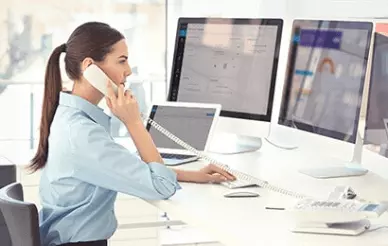 mulher no escritório falando ao telefone
